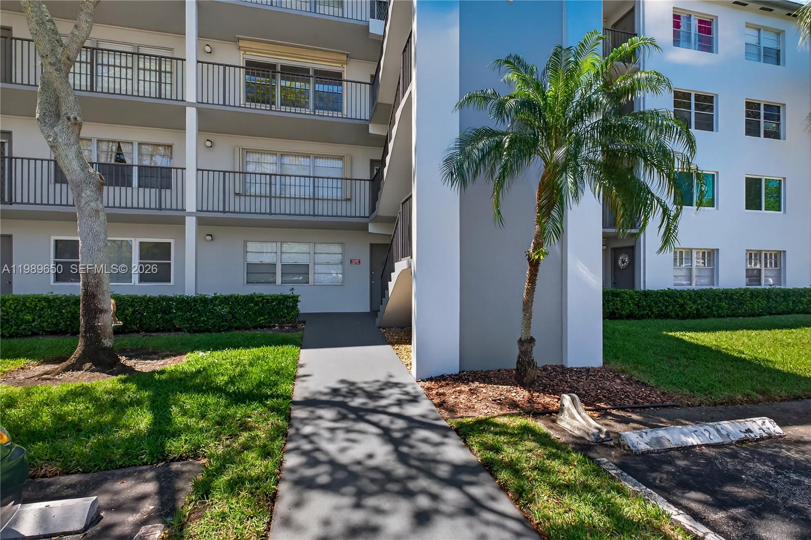 400 Southwest 134th Way, Unit 112F Pembroke Pines, FL 33027 - Photo 22 of 40 a front view of house with yard and green space