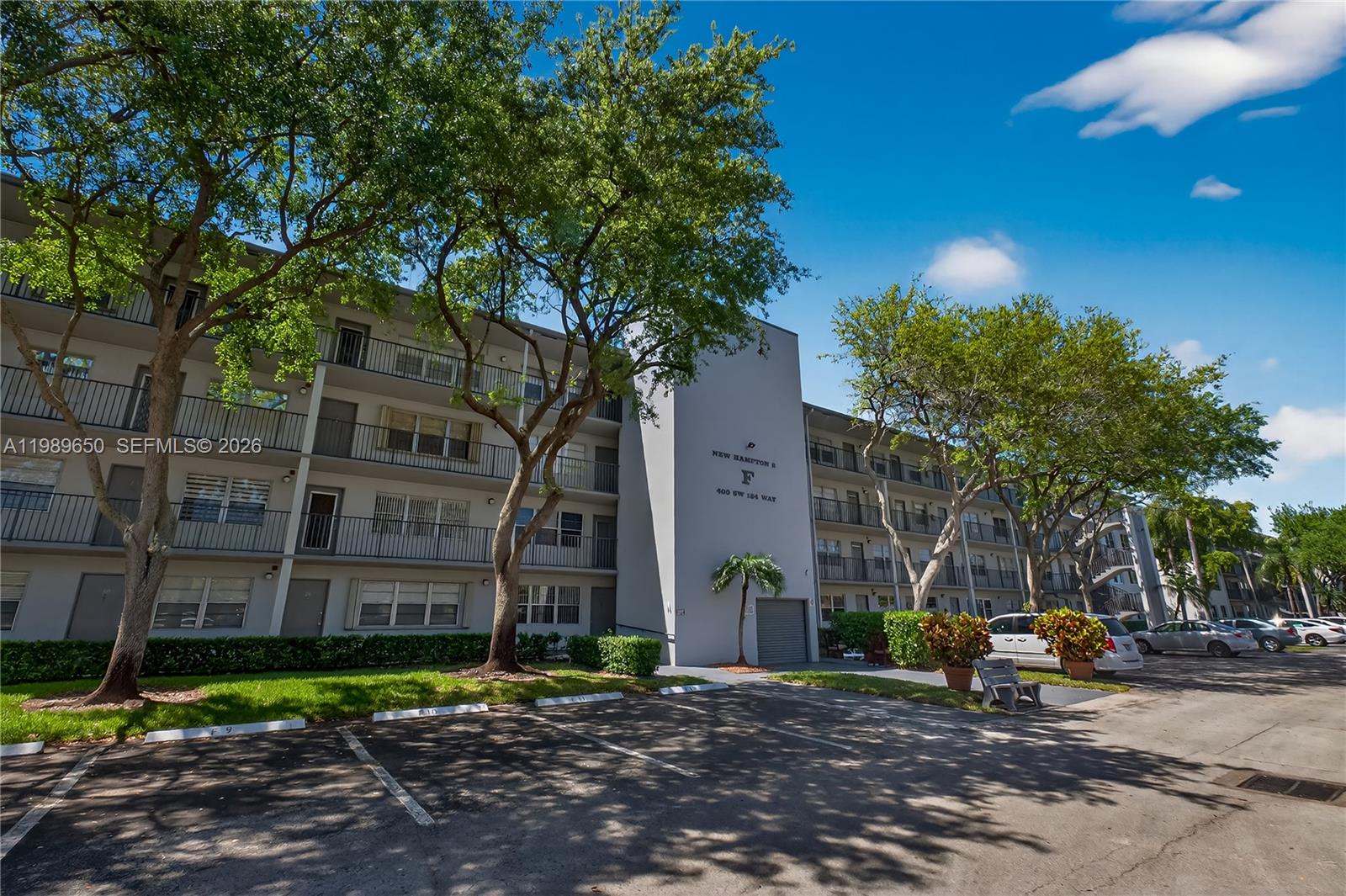 400 Southwest 134th Way, Unit 112F Pembroke Pines, FL 33027 - Photo 23 of 40 a view of a building with a bench in front of building