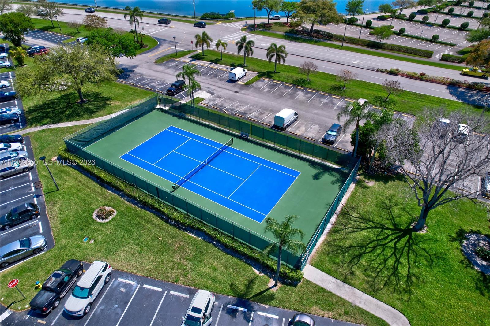 400 Southwest 134th Way, Unit 112F Pembroke Pines, FL 33027 - Photo 28 of 40 an aerial view of a tennis ground with a swimming pool