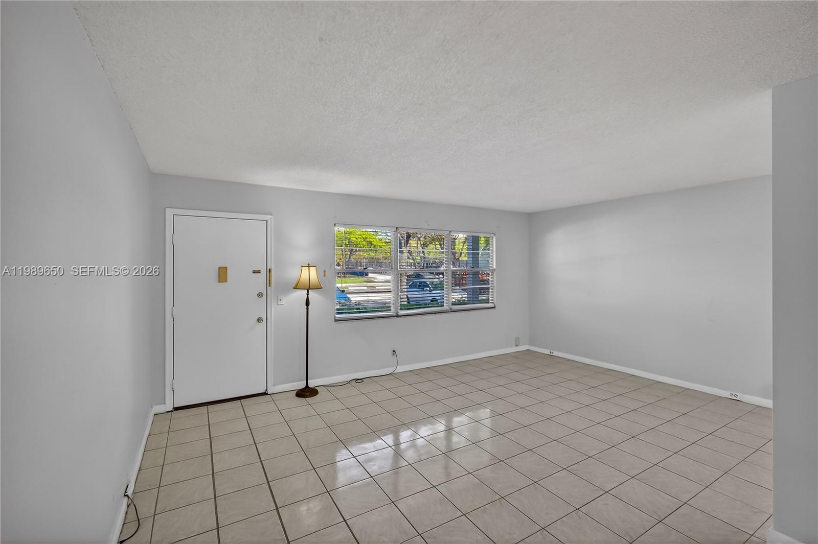 400 Southwest 134th Way, Unit 112F Pembroke Pines, FL 33027 - Photo 5 of 40 a view of an empty room with window