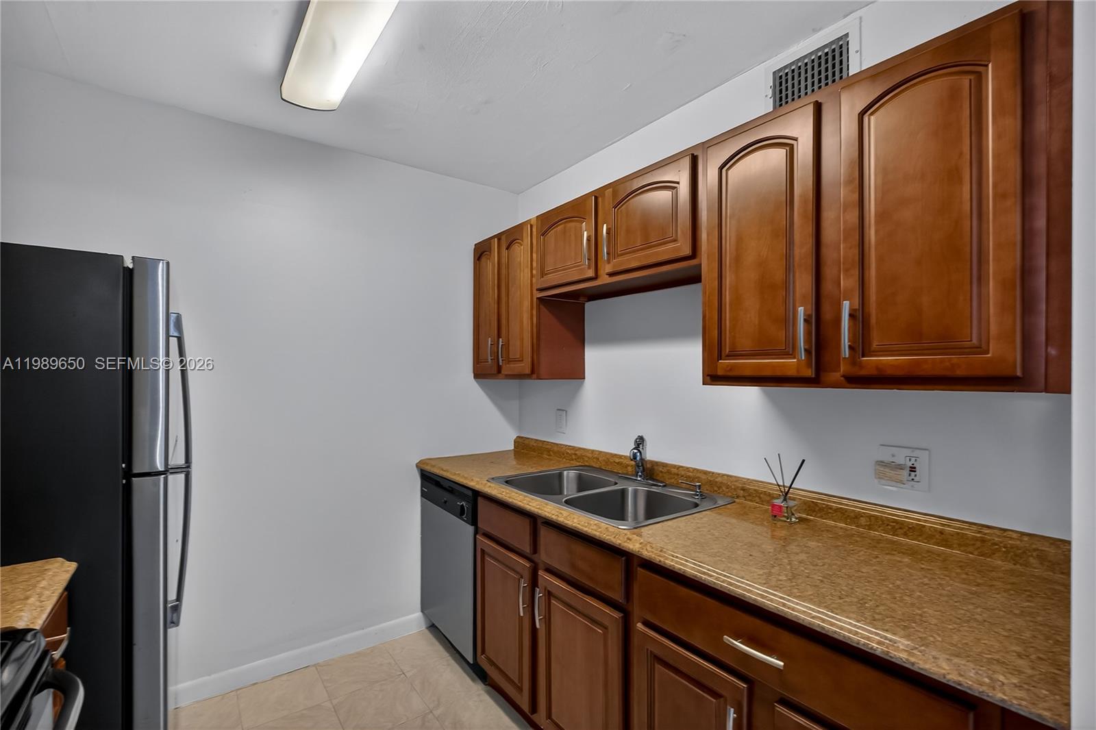 400 Southwest 134th Way, Unit 112F Pembroke Pines, FL 33027 - Photo 10 of 40 a kitchen with a sink and cabinets
