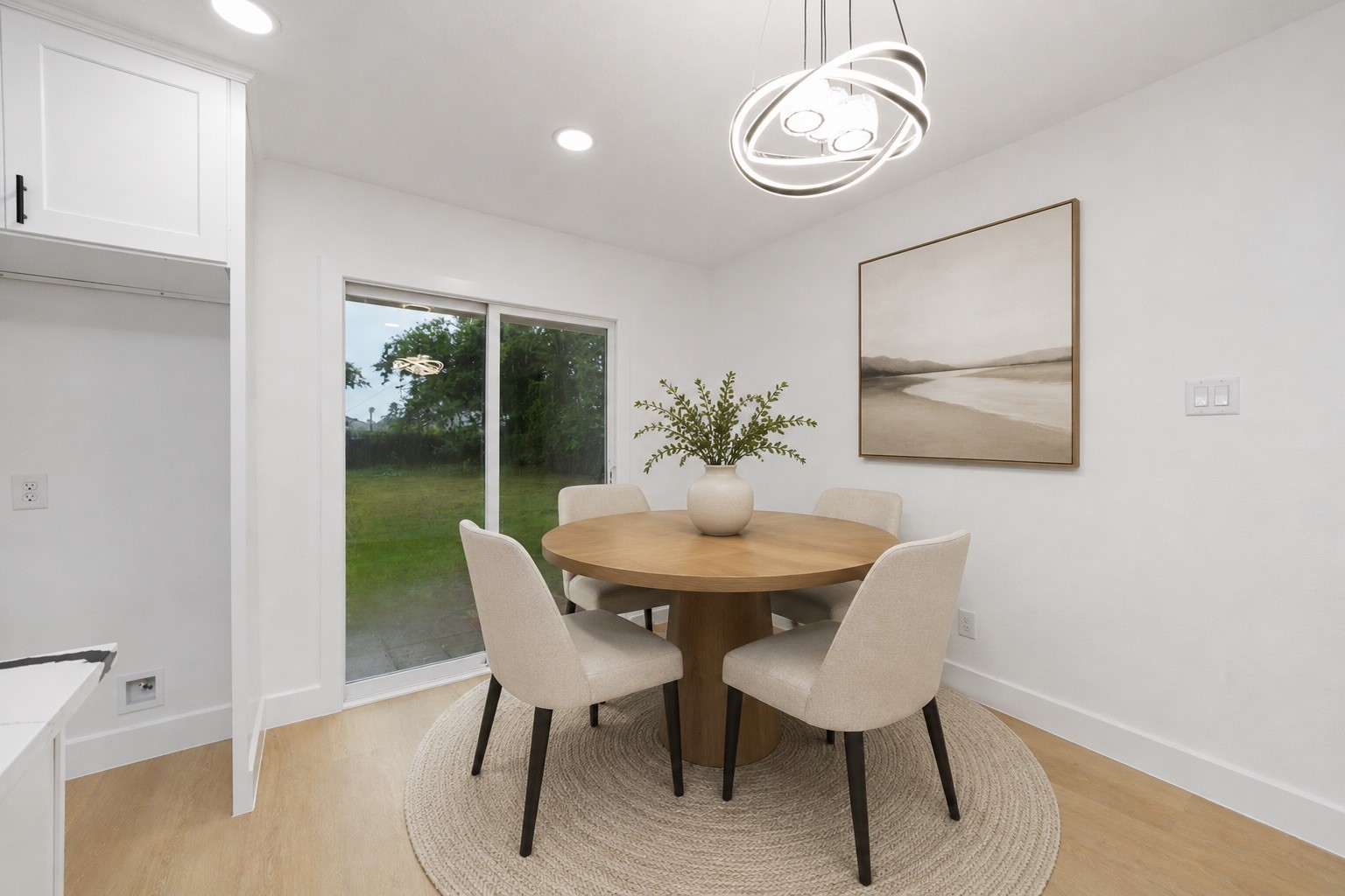 5709 Langley Road Houston, TX 77016 - Photo 11 of 27 Virtually staged. The dining area comfortably accommodates a round dining table and offers an inviting setting for everyday meals or entertaining. Large sliding glass doors provide natural light and easy access to the backyard. Virtual furnishings have been added to help visualize the room's potential.