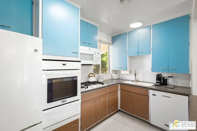 a kitchen with a sink stove top oven and cabinets