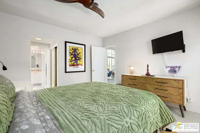 a bedroom with a bed and a flat screen tv