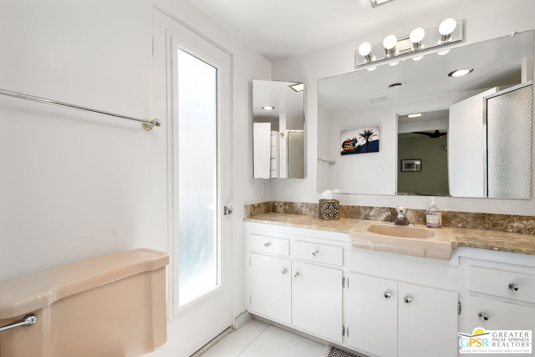 1655 Andee Drive Palm Springs, CA 92264 - Photo 21 of 26 a bathroom with a sink vanity granite and a mirror