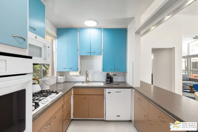 a kitchen with a sink cabinets and appliances