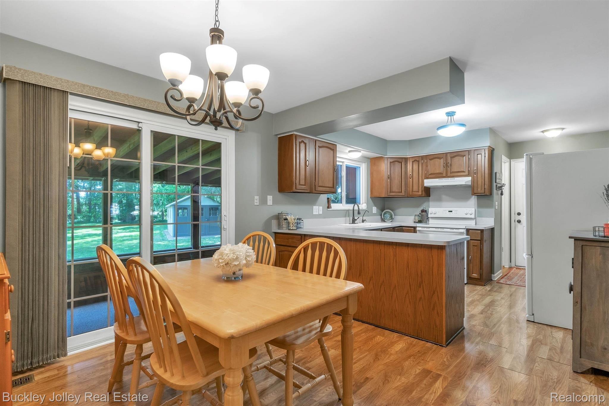 6454 Brighton Road Brighton, MI 48116 - Photo 2 of 28 Step onto the Enclosed Back Porch from the Kitchen.jpg