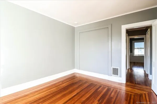 a view of a room with wooden floor