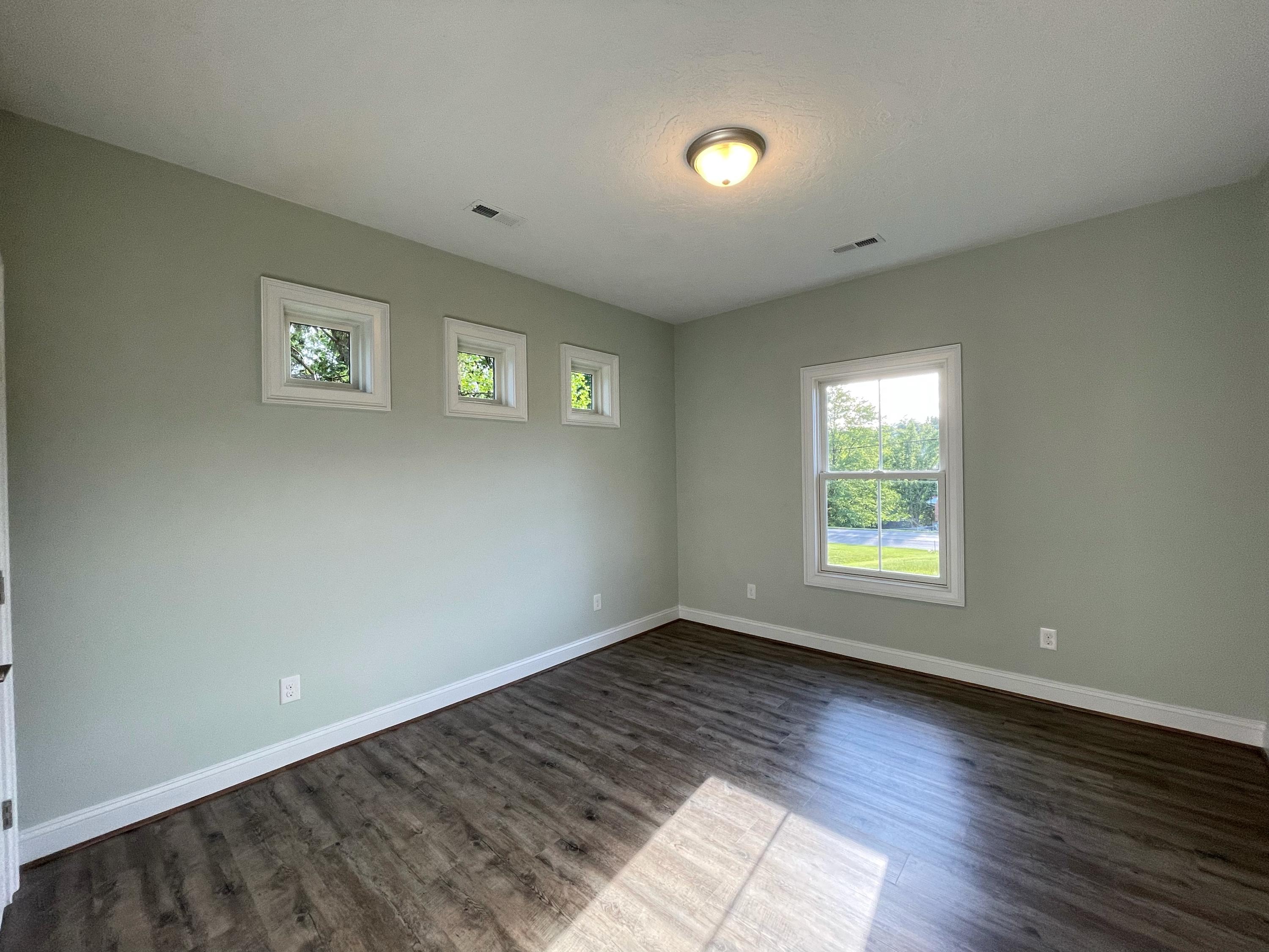 1675 Mountain View Road Vinton, VA 24179 - Photo 20 of 31 a view of an empty room with wooden floor and a window