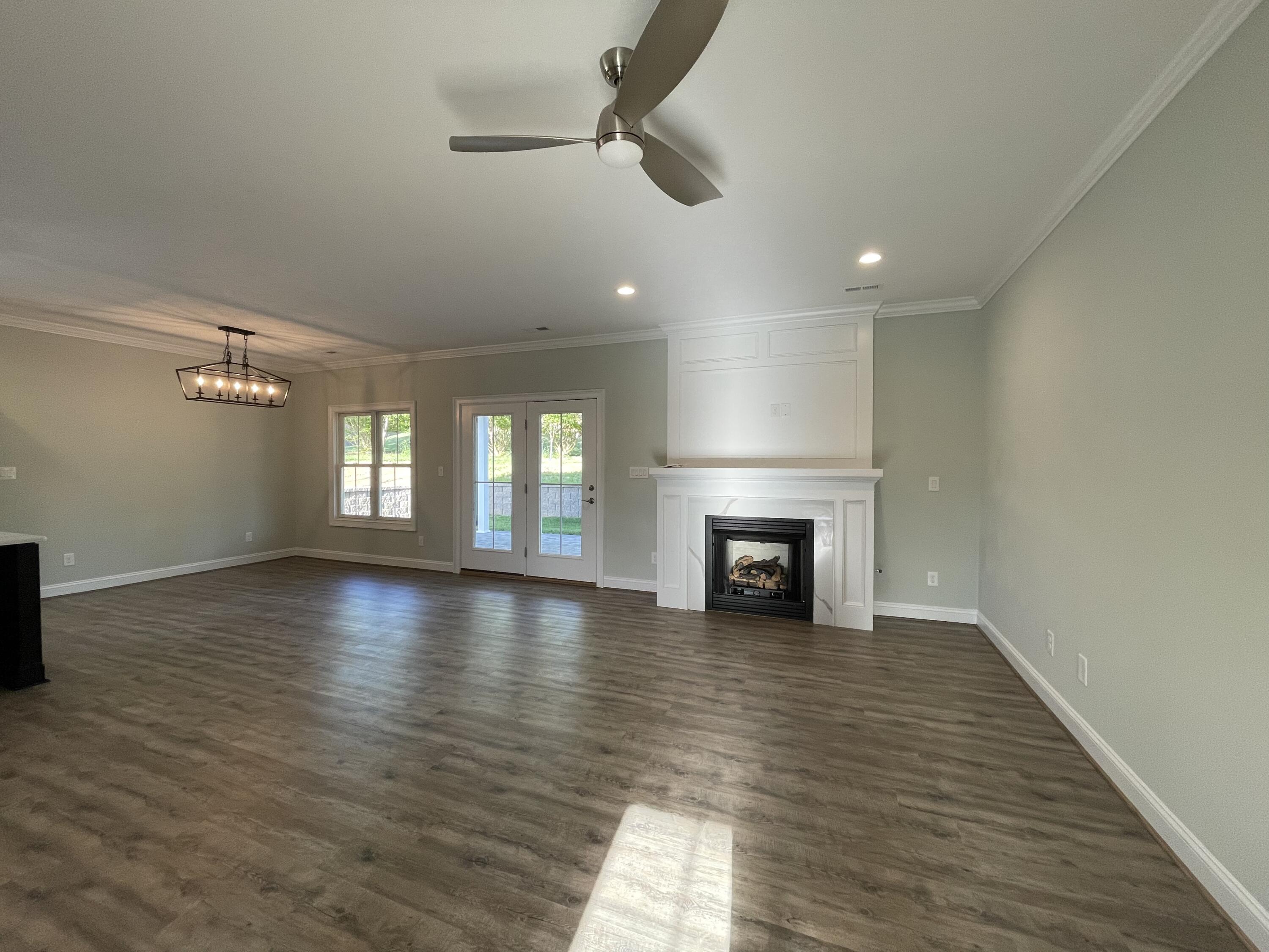 1675 Mountain View Road Vinton, VA 24179 - Photo 3 of 31 an empty room with wooden floor fireplace and windows