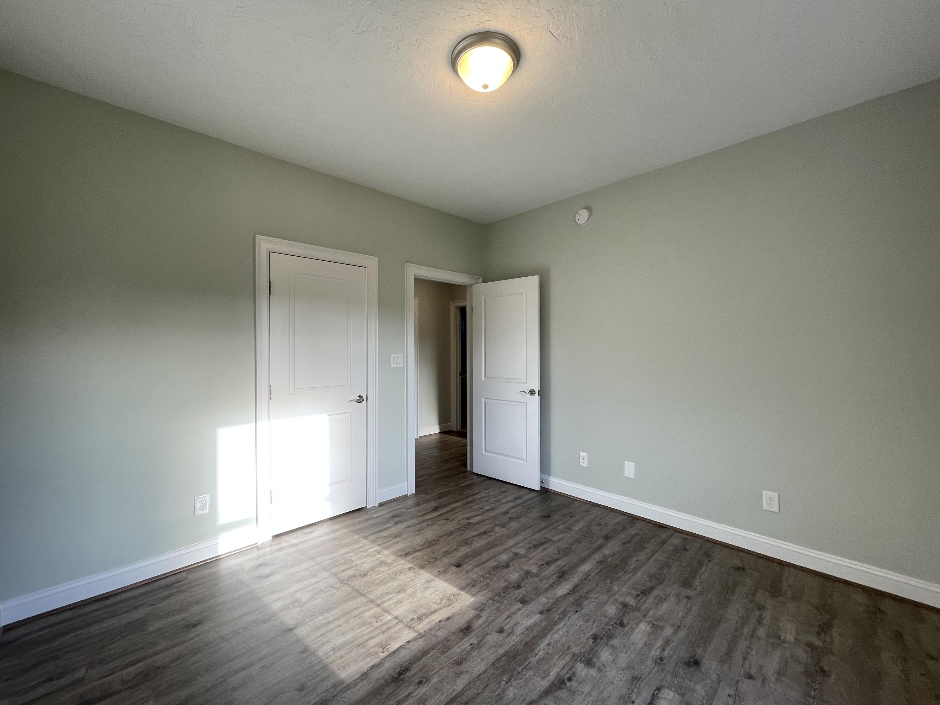 1675 Mountain View Road Vinton, VA 24179 - Photo 23 of 31 an empty room with wooden floor and windows