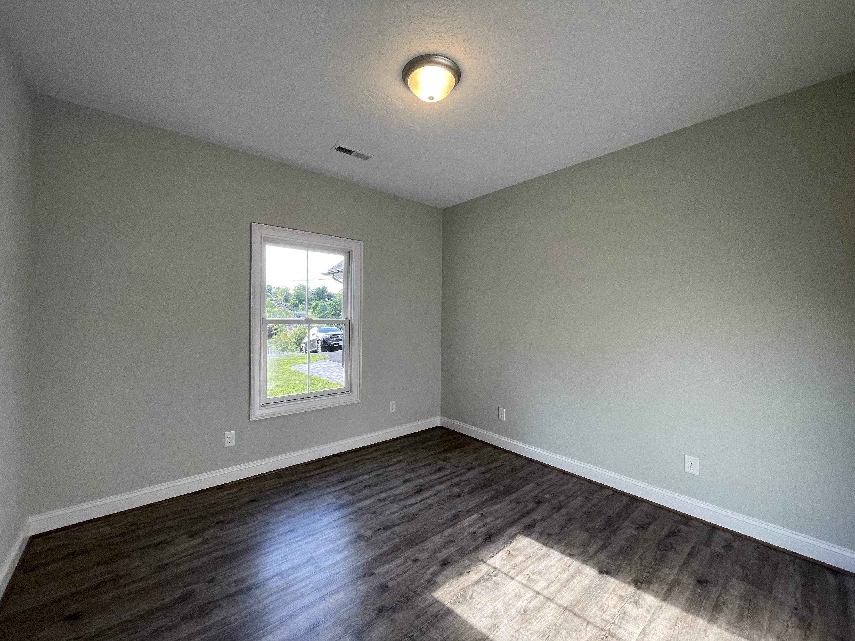 1675 Mountain View Road Vinton, VA 24179 - Photo 24 of 31 an empty room with wooden floor and windows