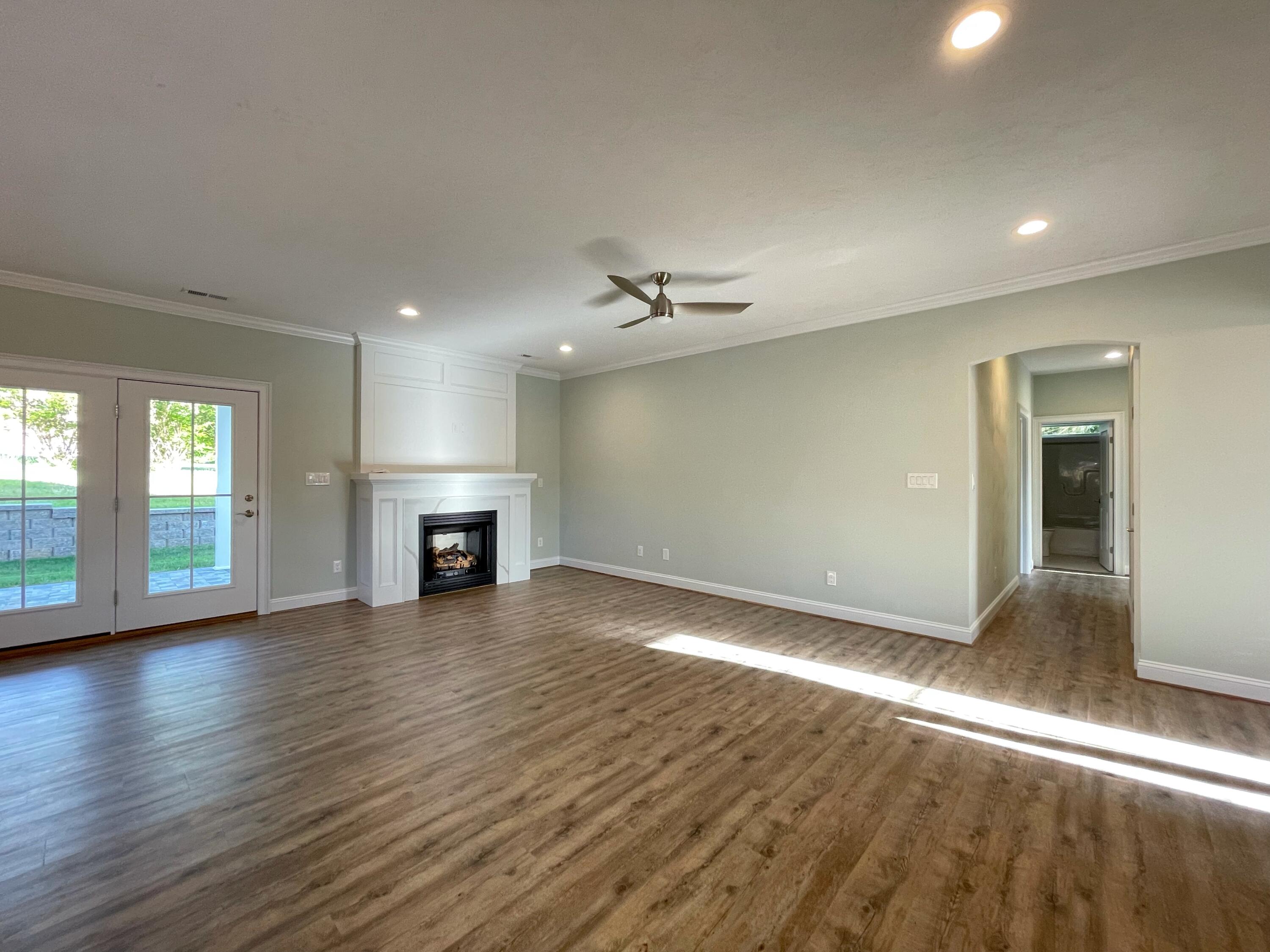 1675 Mountain View Road Vinton, VA 24179 - Photo 4 of 31 an empty room with wooden floor fireplace and windows