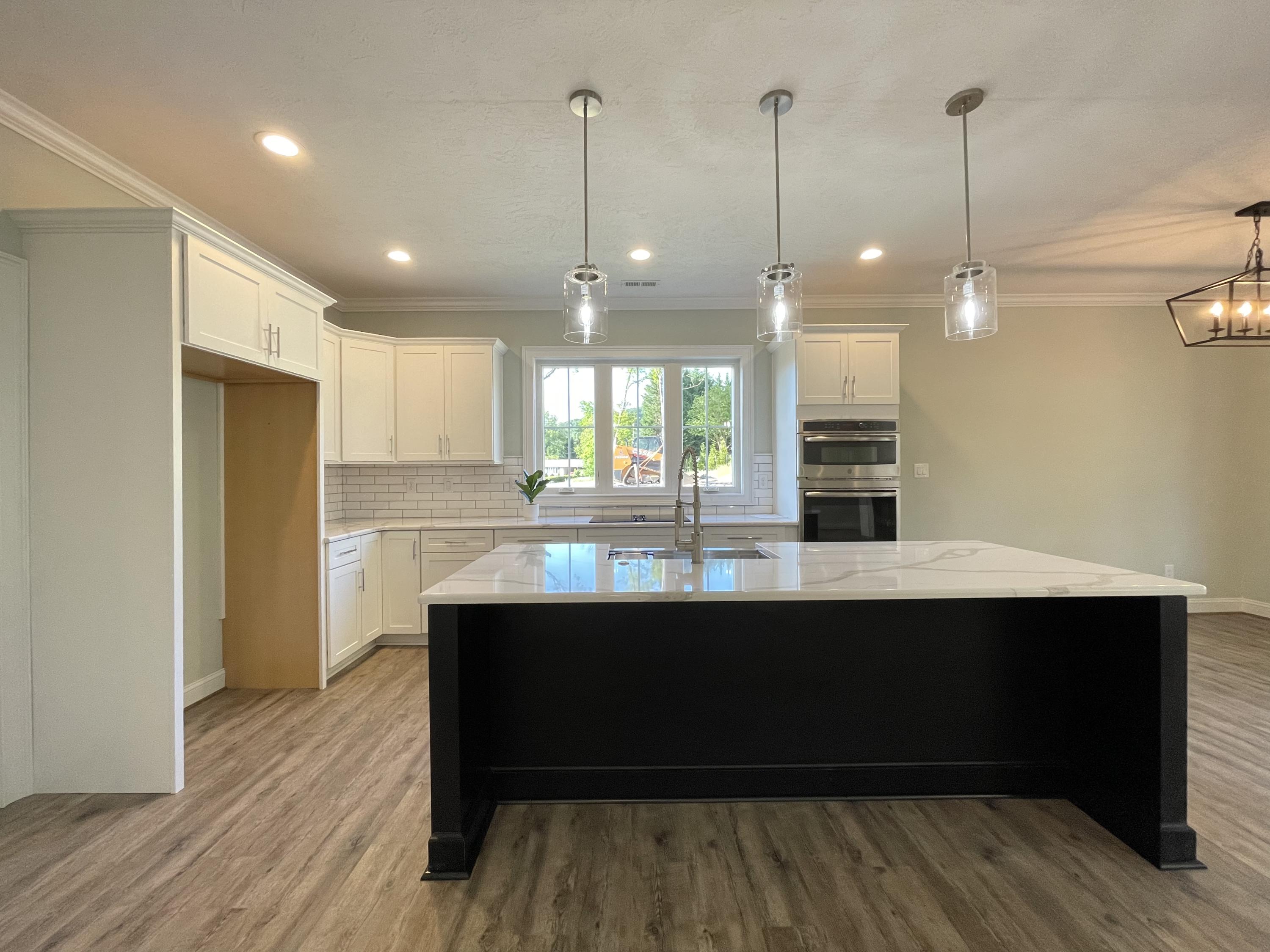1675 Mountain View Road Vinton, VA 24179 - Photo 6 of 31 a room with stainless steel appliances kitchen island granite countertop a sink a refrigerator and wooden floor