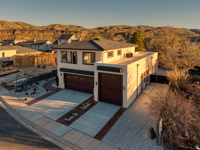 226 East 1100 North Hurricane, UT 84737 - Photo 4 of 49 Mediterranean / spanish-style house with stucco siding, concrete driveway, an attached garage, and a mountain view