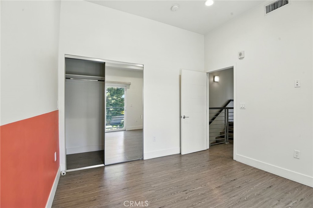 4461 Tujunga Avenue, Unit 101 Studio City, CA 91602 - Photo 11 of 34 an empty room with wooden floor and closet