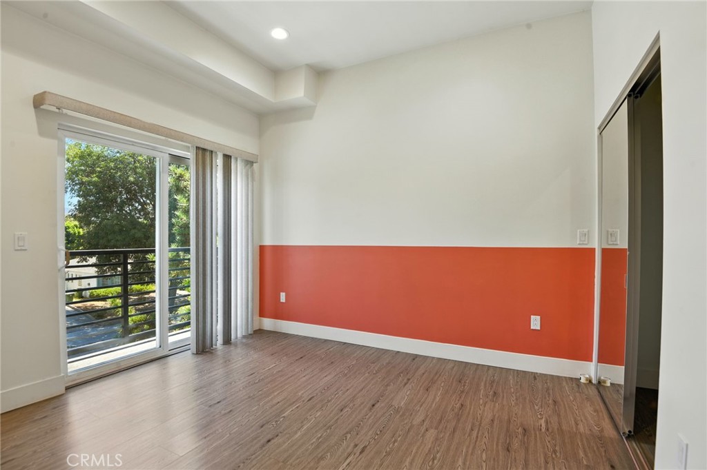 4461 Tujunga Avenue, Unit 101 Studio City, CA 91602 - Photo 12 of 34 an empty room with wooden floor and windows