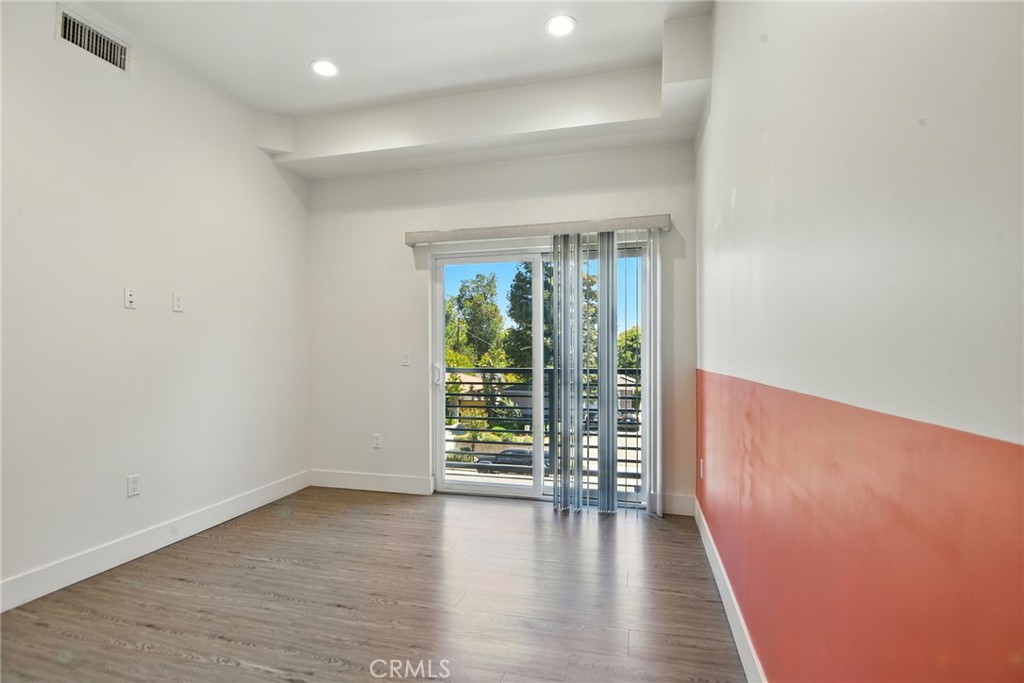 4461 Tujunga Avenue, Unit 101 Studio City, CA 91602 - Photo 13 of 34 wooden floor in an empty room with a window