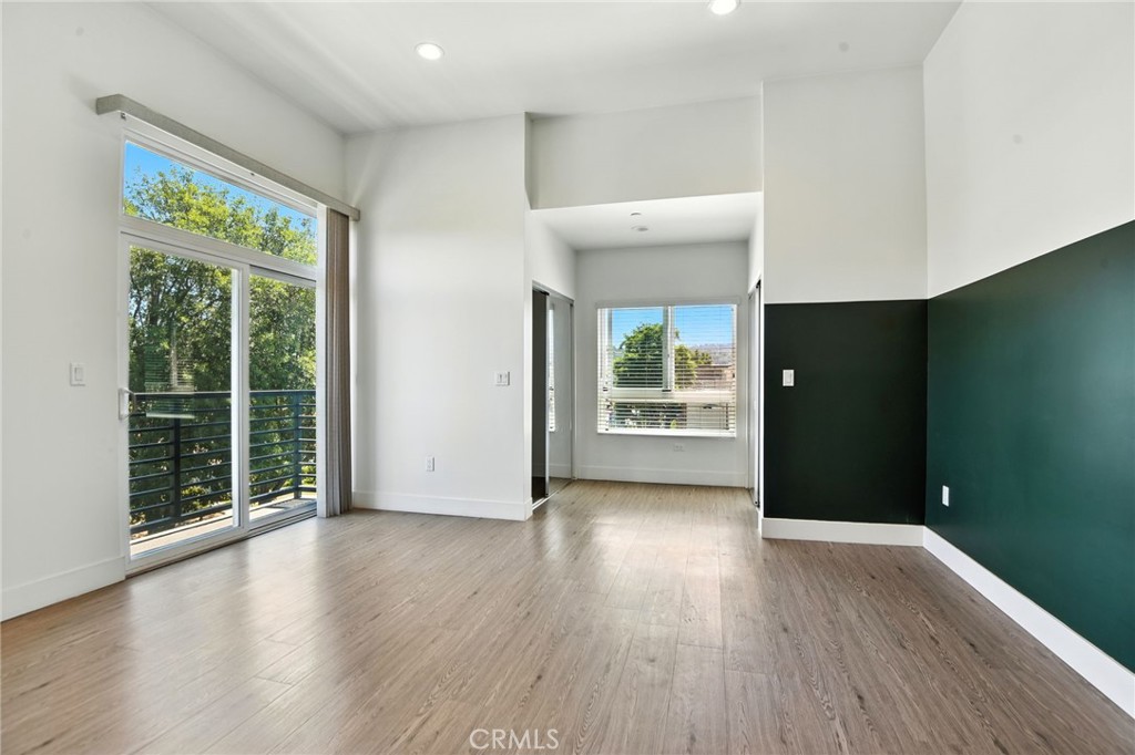 4461 Tujunga Avenue, Unit 101 Studio City, CA 91602 - Photo 16 of 34 an empty room with wooden floor and windows