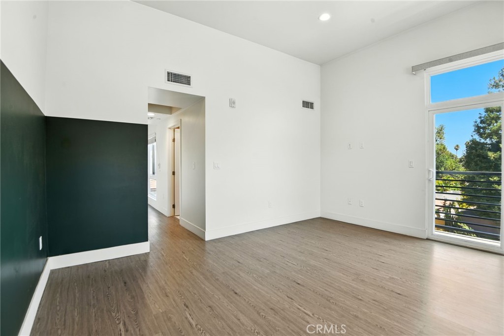 4461 Tujunga Avenue, Unit 101 Studio City, CA 91602 - Photo 19 of 34 an empty room with wooden floor and windows