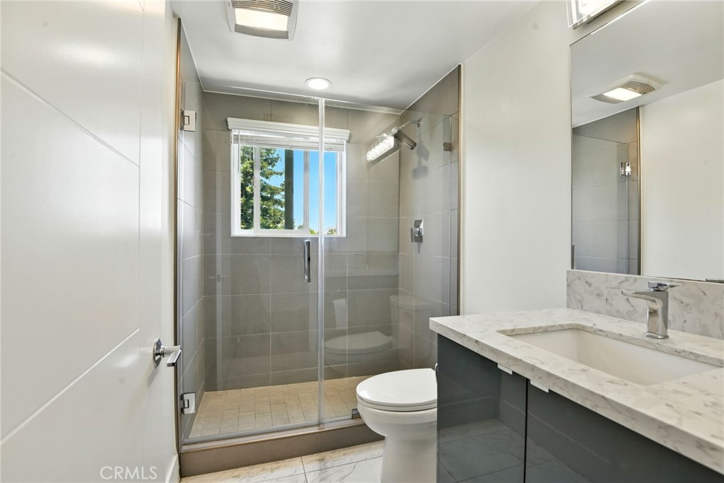 4461 Tujunga Avenue, Unit 101 Studio City, CA 91602 - Photo 26 of 34 a bathroom with a granite countertop sink toilet and shower