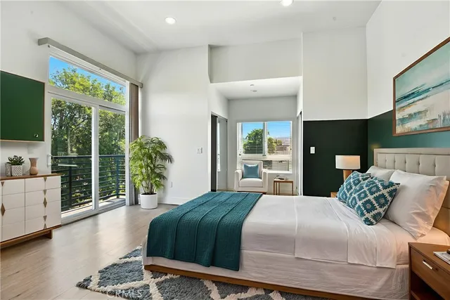 a bedroom with a large bed and a large window