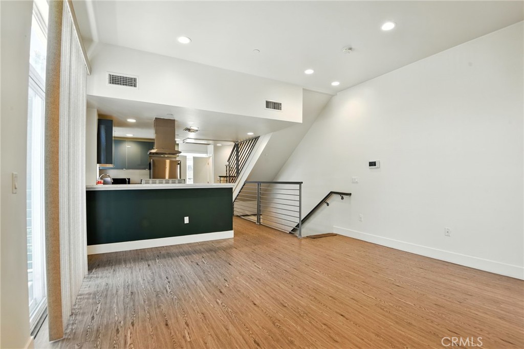 4461 Tujunga Avenue, Unit 101 Studio City, CA 91602 - Photo 4 of 34 a view of a room with wooden floor and stairs