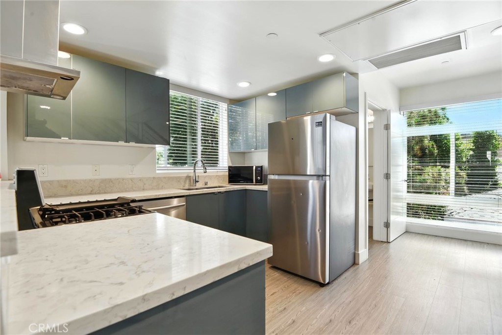 4461 Tujunga Avenue, Unit 101 Studio City, CA 91602 - Photo 5 of 34 a kitchen with stainless steel appliances granite countertop a refrigerator a sink and a stove top oven