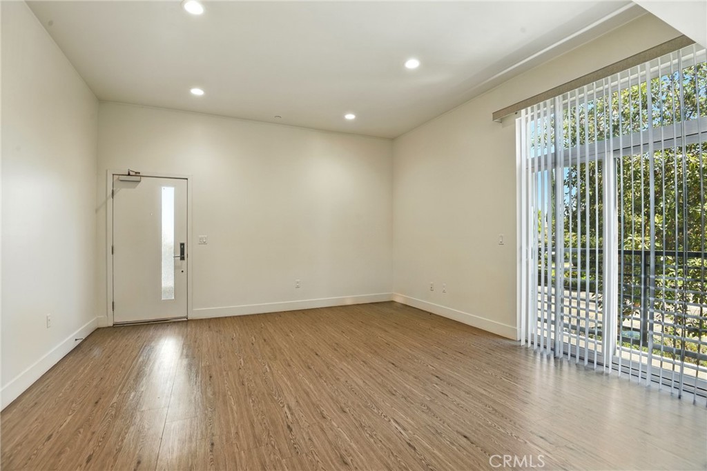4461 Tujunga Avenue, Unit 101 Studio City, CA 91602 - Photo 7 of 34 wooden floor in an empty room with a window