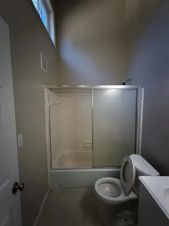 a bathroom with a toilet and a shower
