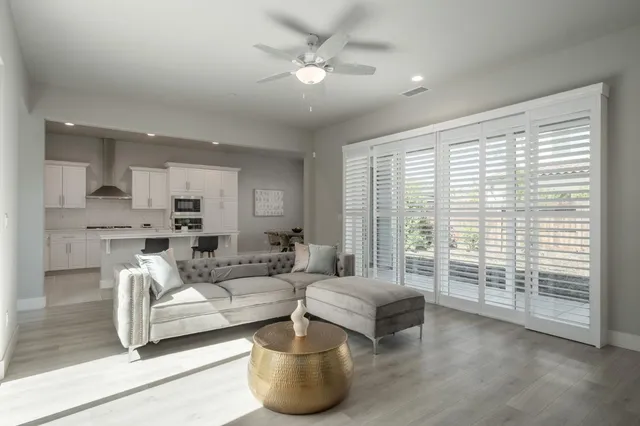 a living room with furniture and a large window