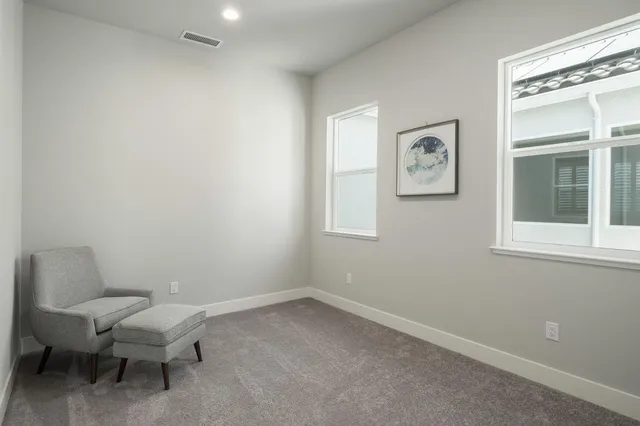a bathroom with a toilet and a window