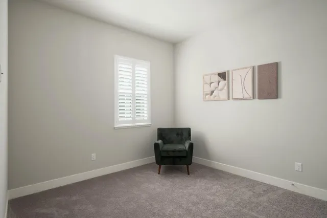 an empty room with chair and piano