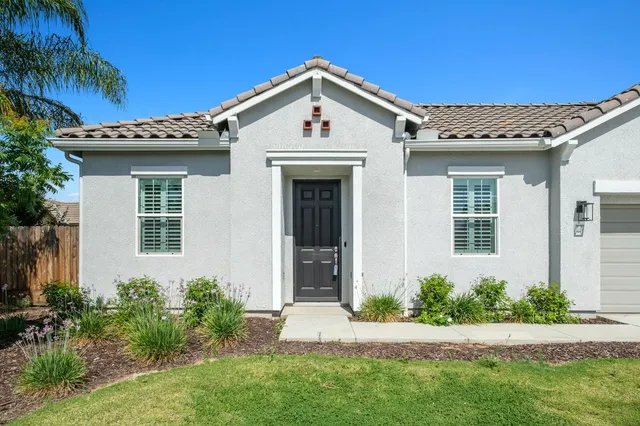a front view of a house with a yard
