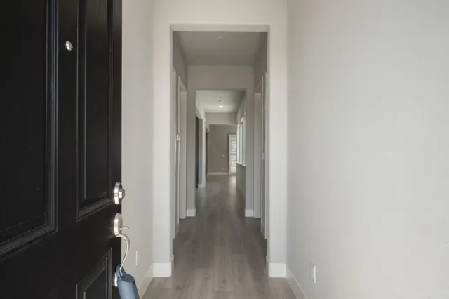 a view of a hallway with wooden floor