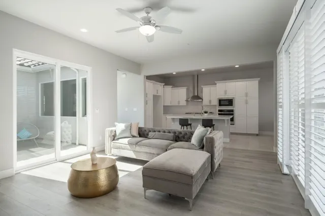 a living room with furniture and a chandelier