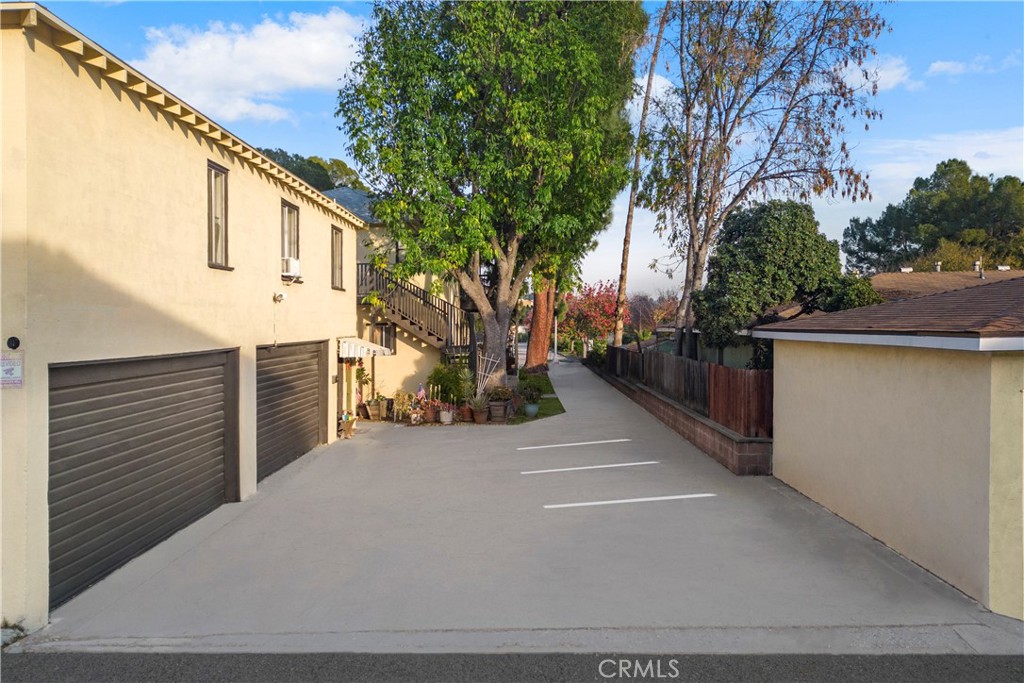 1255 Del Rey Avenue Pasadena, CA 91107 - Photo 3 of 3 a backyard of a house with large trees and garage