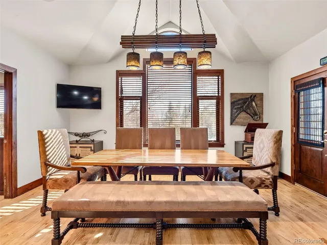 a kitchen with a table chairs stove and cabinets