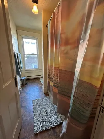 a bathroom with a granite countertop shower and a tub