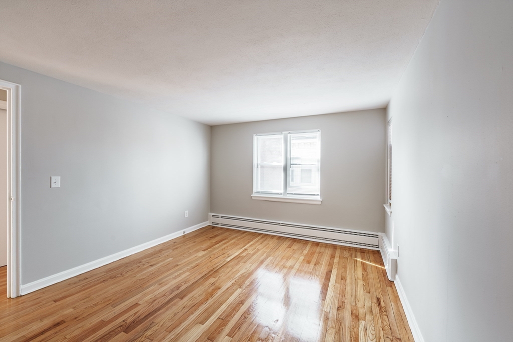 246-262 Union Street Springfield, MA 01105 - Photo 8 of 24 an empty room with wooden floor and windows