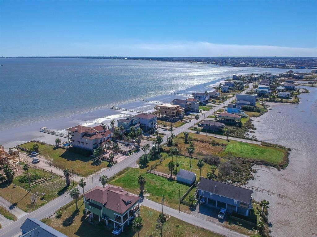 1816-tbdt Todville Road Seabrook, TX 77586 - Photo 10 of 24 This aerial view showcases a serene coastal neighborhood with waterfront homes, each offering stunning views of the expansive bay. The area features lush greenery and well-maintained roads. Ideal for seaside living.