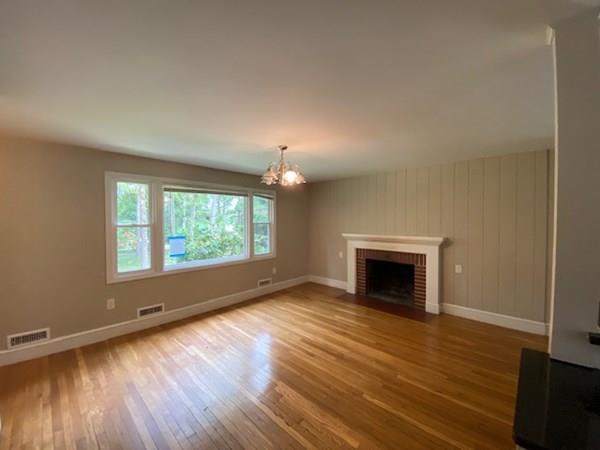 490 Rocky Hill Road Scituate, RI 02857 - Photo 33 of 33 an empty room with wooden floor fireplace and windows