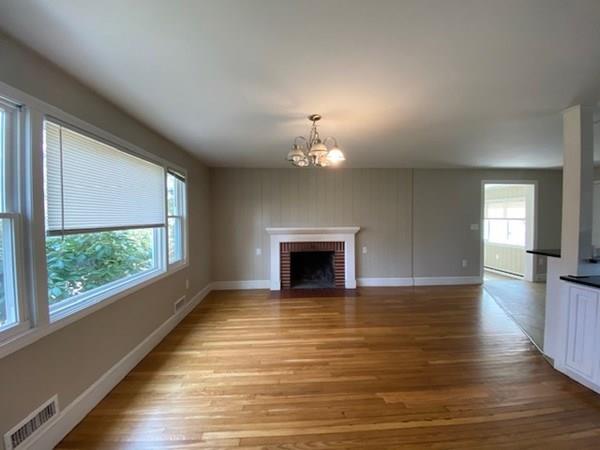 490 Rocky Hill Road Scituate, RI 02857 - Photo 6 of 33 a view of a livingroom with a fireplace wooden floor and windows