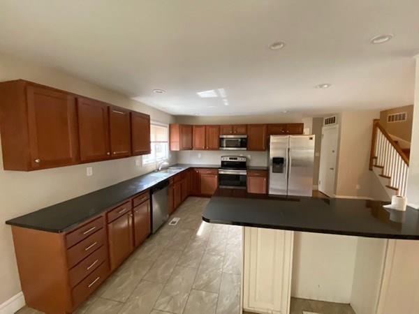 490 Rocky Hill Road Scituate, RI 02857 - Photo 8 of 33 a large kitchen with stainless steel appliances cabinets a sink and a counter top space