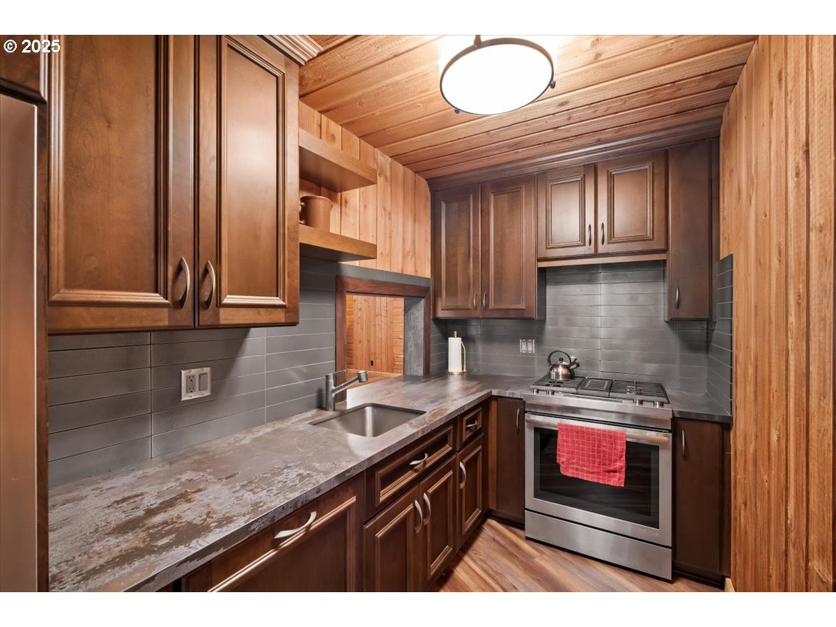51720 Northwest Hayward Road Manning, OR 97125 - Photo 30 of 48 a kitchen with stainless steel appliances granite countertop a sink stove and cabinets
