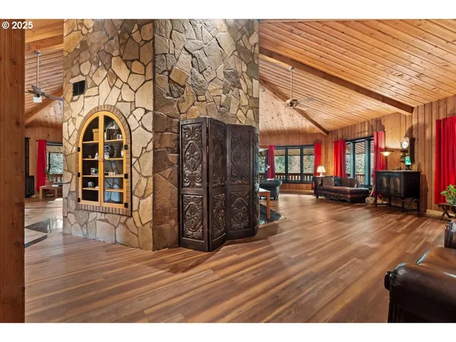 a living room filled with furniture and a floor to ceiling window