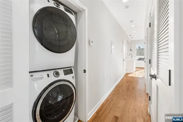 a view of a hallway with washer and dryer
