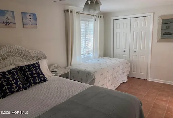 a bedroom with a bed and a mirror