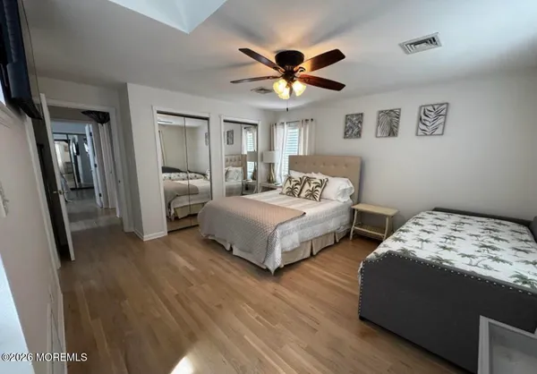 a bedroom with a bed dresser and a window
