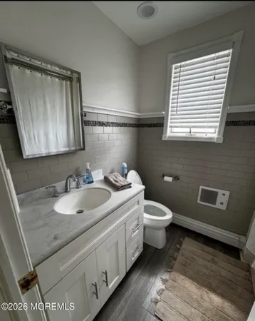 a spacious bathroom with a double vanity sink a mirror and a bathtub